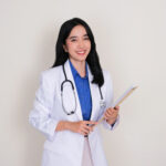 young asian doctor smiling friendly at the camera
